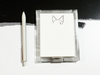 Acrylic notepad holder with pet ears with a pen on a white background
