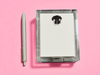 Acrylic notepad with paw design with a pen on a pink background