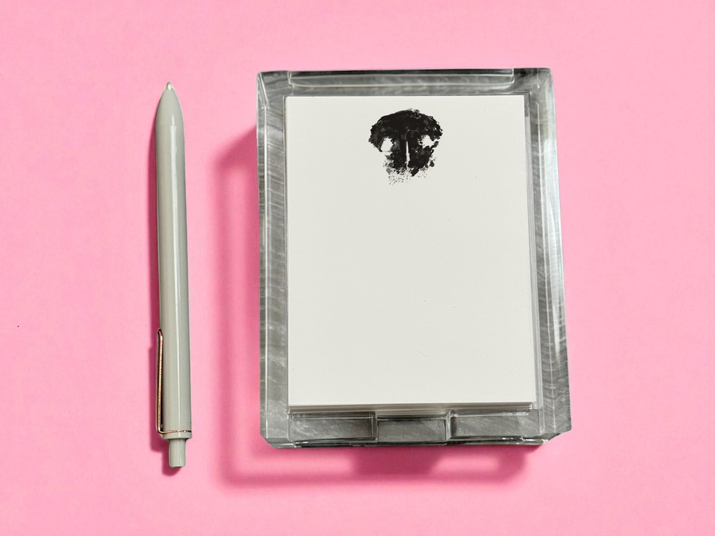 Acrylic notepad with paw design with a pen on a pink background
