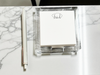 Clear acrylic notepad holder with pet ears with a pen and paper on a marble surface