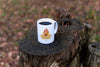 White mug with autumn leaf imprinted with a paw design on a bed of autumn leaves