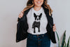 Linocut boston terrier graphic featured on a white Bella + Canvas t-shirt. Model is wearing a circle necklace and a leather jacket.