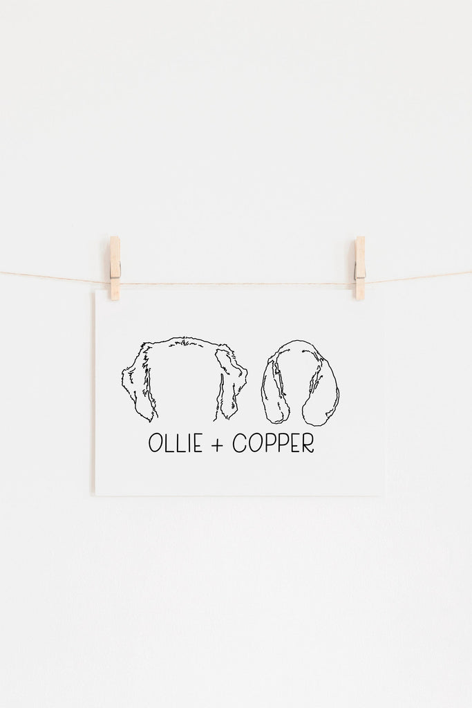 8"x10" wall art print featuring a hand drawn illustration of dog and cat ears, hanging on clothes pins and in black and white.