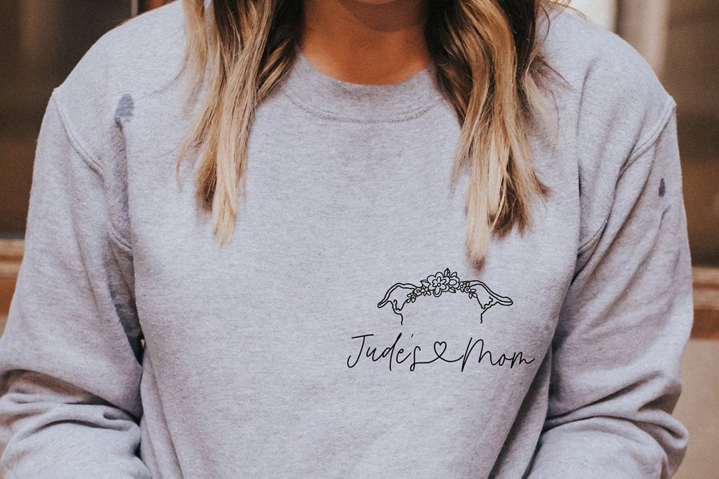 Personalized Pocket Dog, Cat, or Other Pet's Ears Outline Tattoo Inspired Crew Neck Bella + Canvas Unisex Sweatshirt in Heather Gray - Personalized with "Jude's Mom" in heart cursive and dog ears wearing a halo crown.