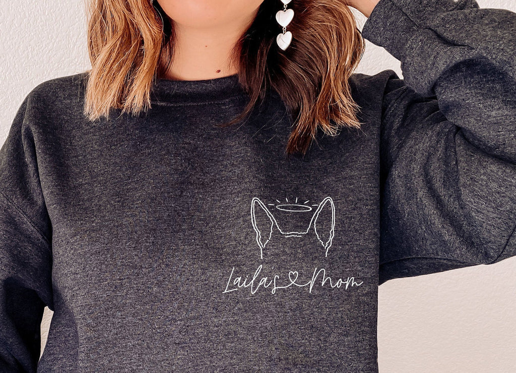 Personalized Pocket Dog, Cat, or Other Pet's Ears Outline Tattoo Inspired Crew Neck Bella + Canvas Unisex Sweatshirt in Dark Grey - Personalized with "Laila's Mom" in heart cursive and dog ears with a halo