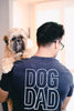 Barkley & Wagz dark grey Bella + Canvas t-shirt with Dog Dad printed in white on the back. Model is wearing glasses and holding a very cute Shih Tzu named Oscar.