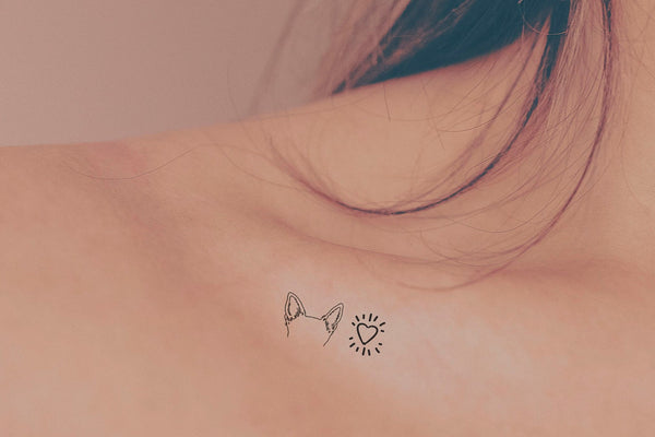 Tattoo of her dogs ears located on the inner forearm